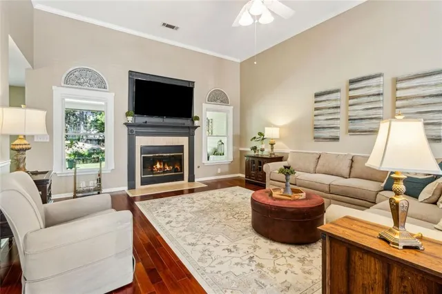 a living room with furniture and wooden floor