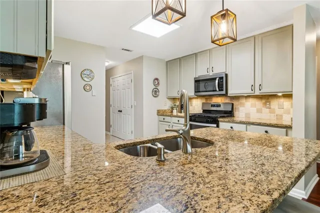 a view of a kitchen counter top a sink and dishwasher