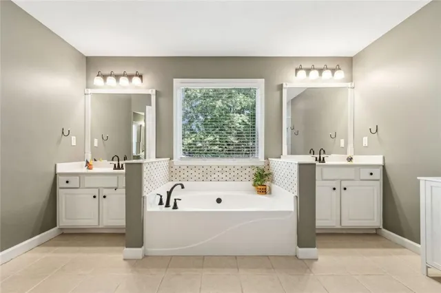 a bedroom with a bed a dresser and a window