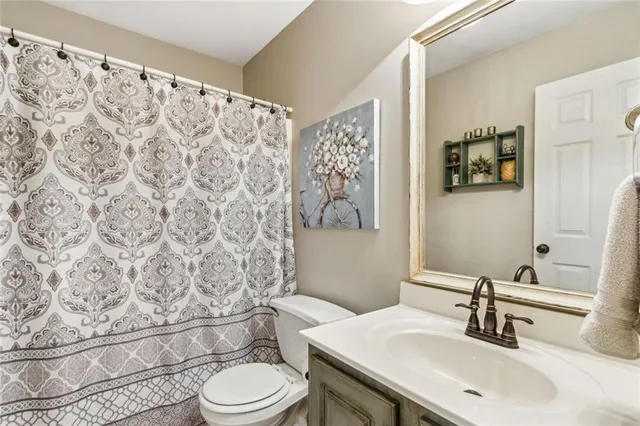 a kitchen with granite countertop a refrigerator and wooden floor