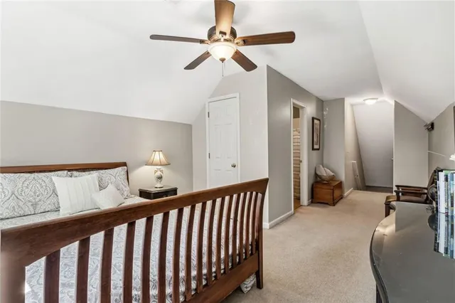 a living room with furniture and a view of kitchen