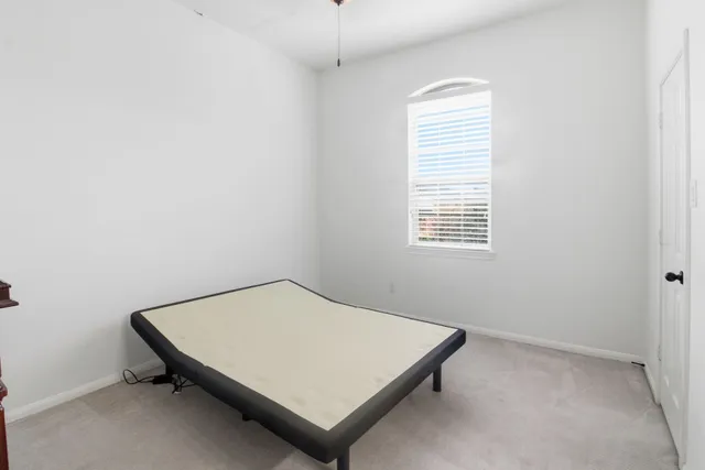 a room with a bed and a window