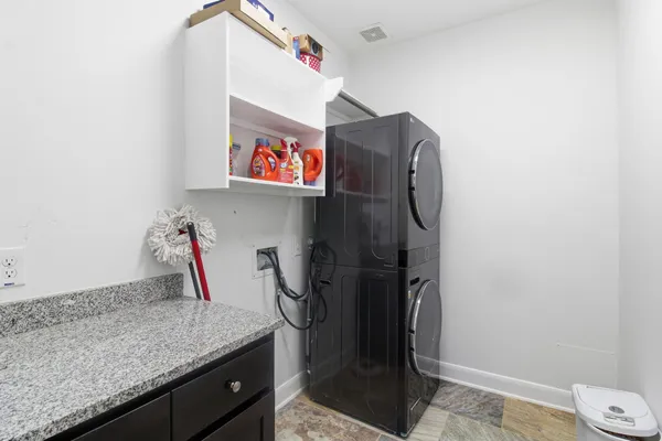 a utility room with cabinets and a sink