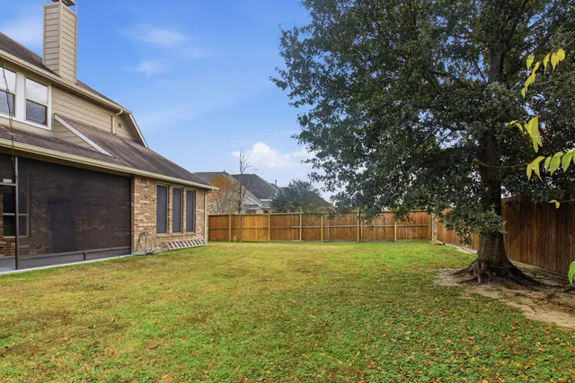 a view of a backyard with a large tree
