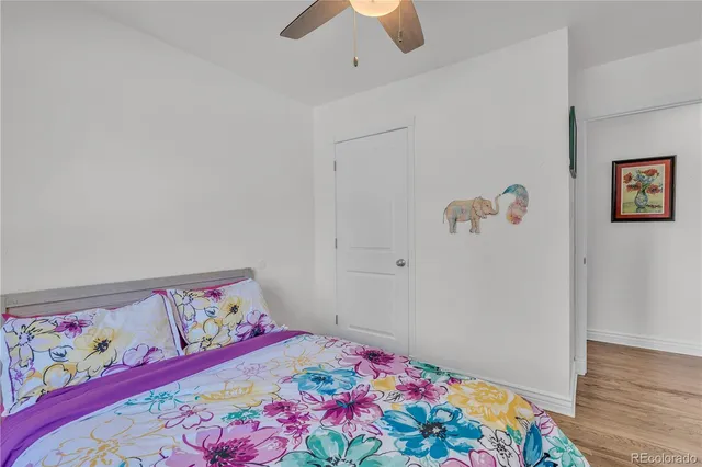 a bedroom with a bed and a painting on the wall