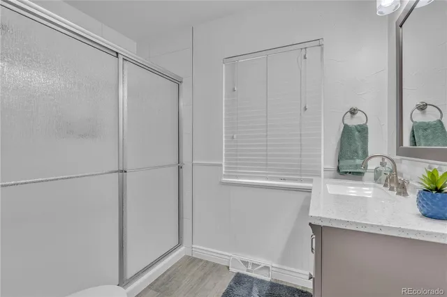 a bathroom with a shower and a sink