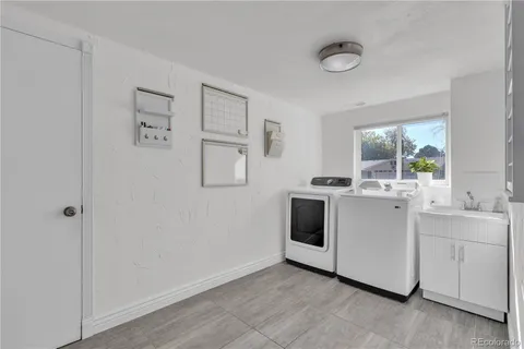 a view of cabinets a sink and a stove top oven