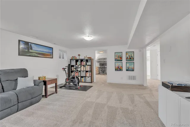 a living room with furniture and white walls