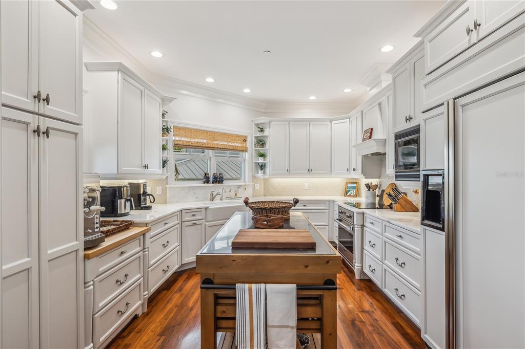 13310 Anglers Way Placida, FL 33946 - Photo 11 of 43 a kitchen with white cabinets and appliances