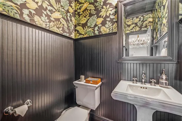 a bathroom with a sink a toilet and a mirror