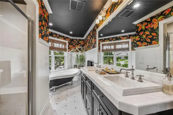 a bathroom with a sink mirror and a bathtub