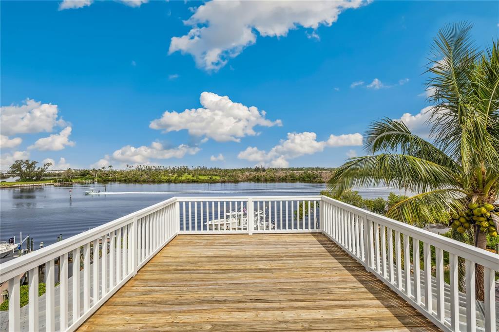 13310 Anglers Way Placida, FL 33946 - Photo 19 of 43 a view of balcony with wooden floor and lake view