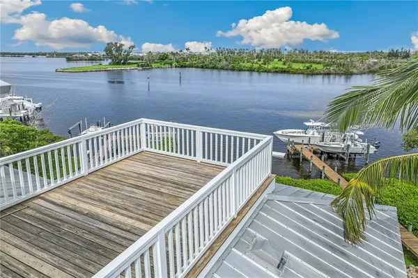 a view of a wooden deck with lake view