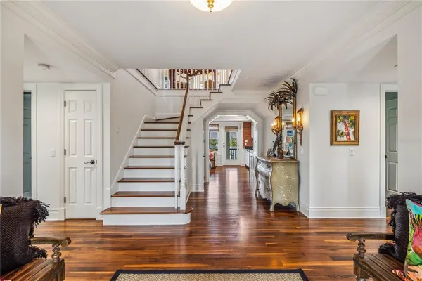 a view of entryway and hall with wooden floor