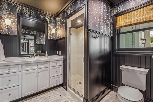 a bathroom with a granite countertop toilet sink and shower