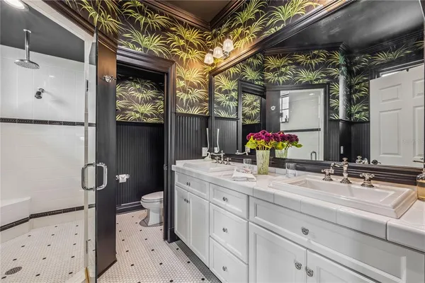 a bathroom with a sink mirror and toilet