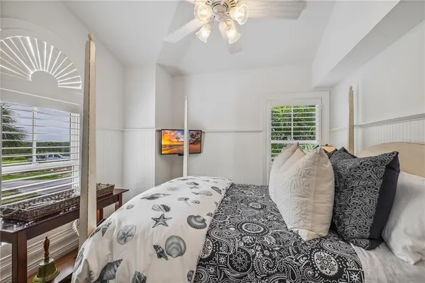 a bed sitting in a bedroom next to a window