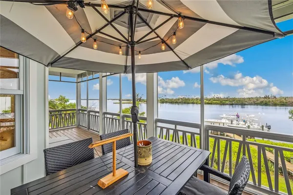 a view of a balcony with couch and wooden floor
