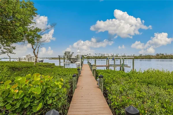 a view of a fountain in front of house with a big yard