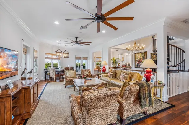 a living room with furniture kitchen view and a large window