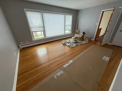 a room with wooden floor and furniture
