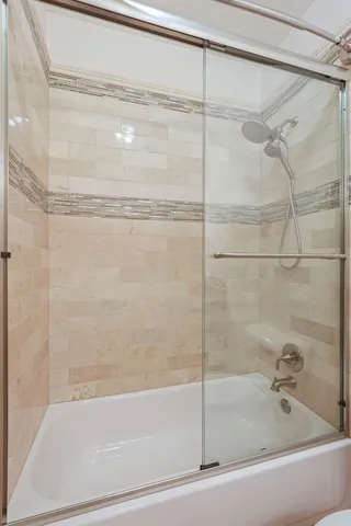 a bathroom with a bathtub and a shower