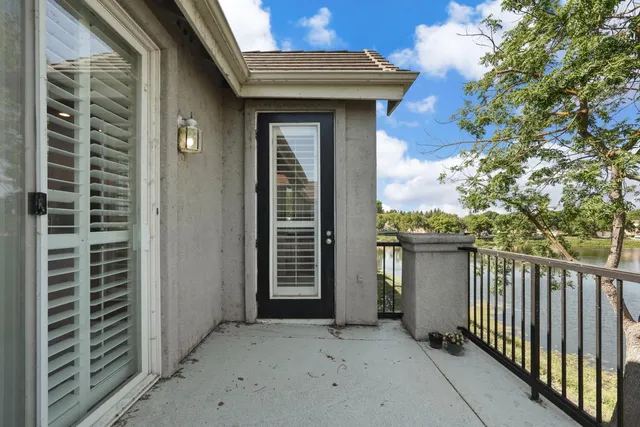 a balcony with a bench and trees
