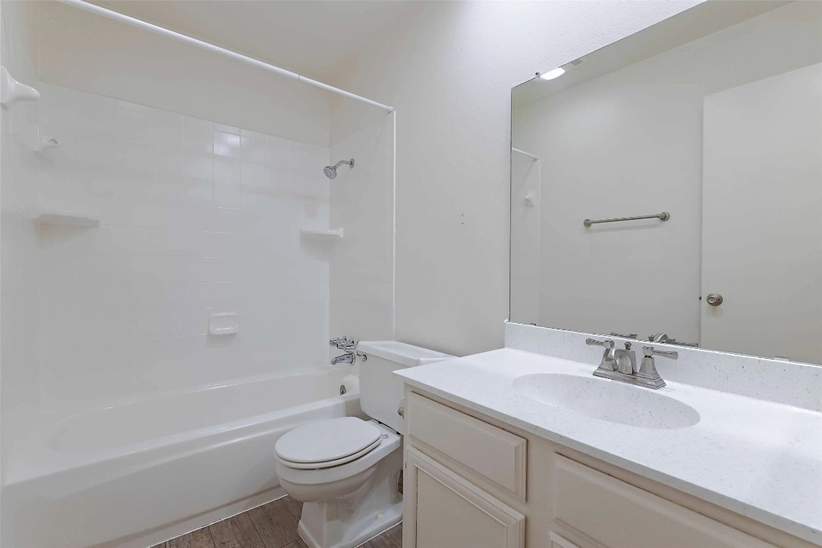 8405 Bent Tree Road, Unit 3414 Austin, TX 78759 - Photo 11 of 20 Bathroom featuring vanity, shower / bathtub combination, and wood finished floors