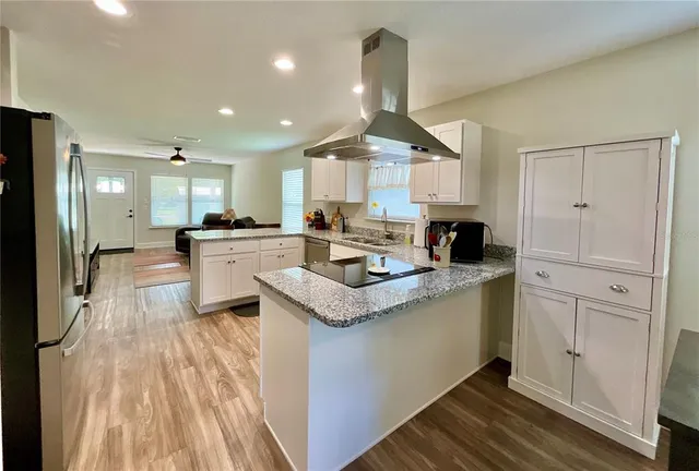 a view of a workspace with furniture and wooden floor