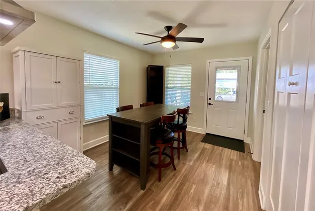 a view of a dining room with furniture and a window