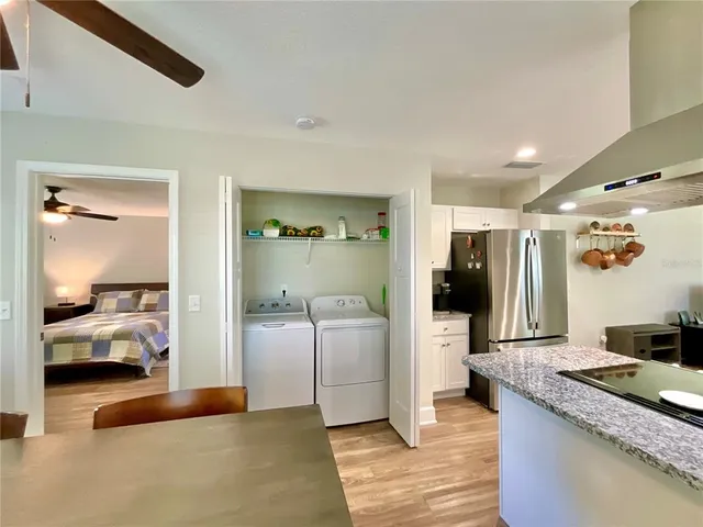 a bedroom with a bed a window and a flat screen television