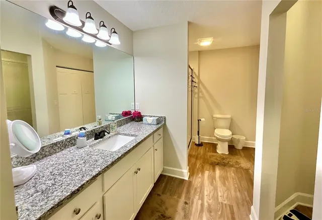 a bathroom with a mirror sink and bathtub