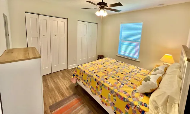 a bedroom with a bed and a chandelier