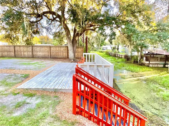 a view of yard with swimming pool and green space