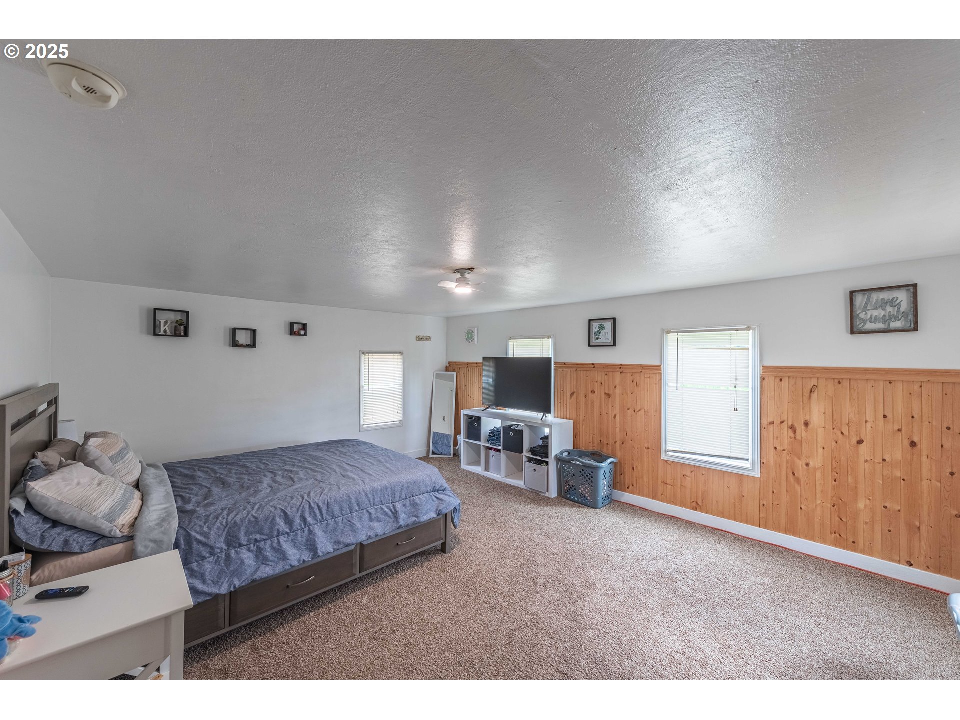 3236 Sheridan Avenue North Bend, OR 97459 - Photo 15 of 20 a spacious bedroom with a bed and window