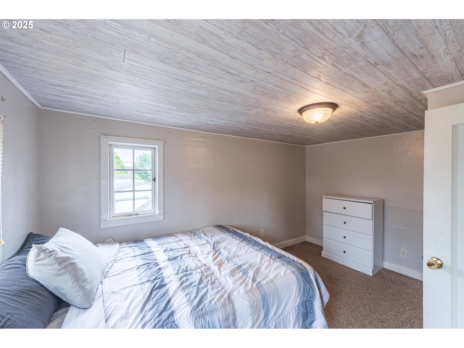 3236 Sheridan Avenue North Bend, OR 97459 - Photo 16 of 20 a bedroom with a bed and a window