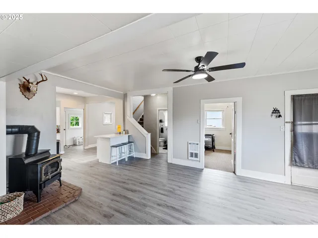 a living room with couches and a view of kitchen