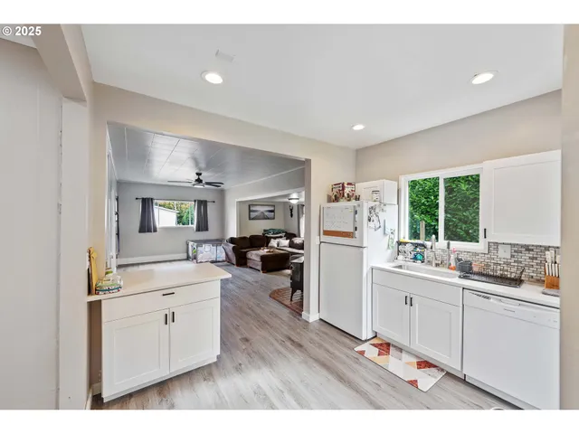 a kitchen with a sink stove and cabinets