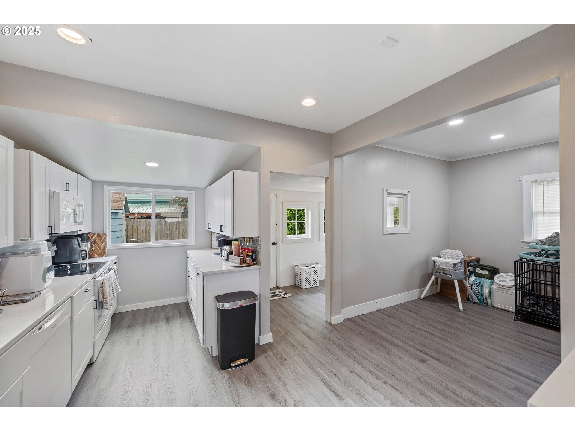 3236 Sheridan Avenue North Bend, OR 97459 - Photo 8 of 20 a kitchen with a table chairs refrigerator and cabinets