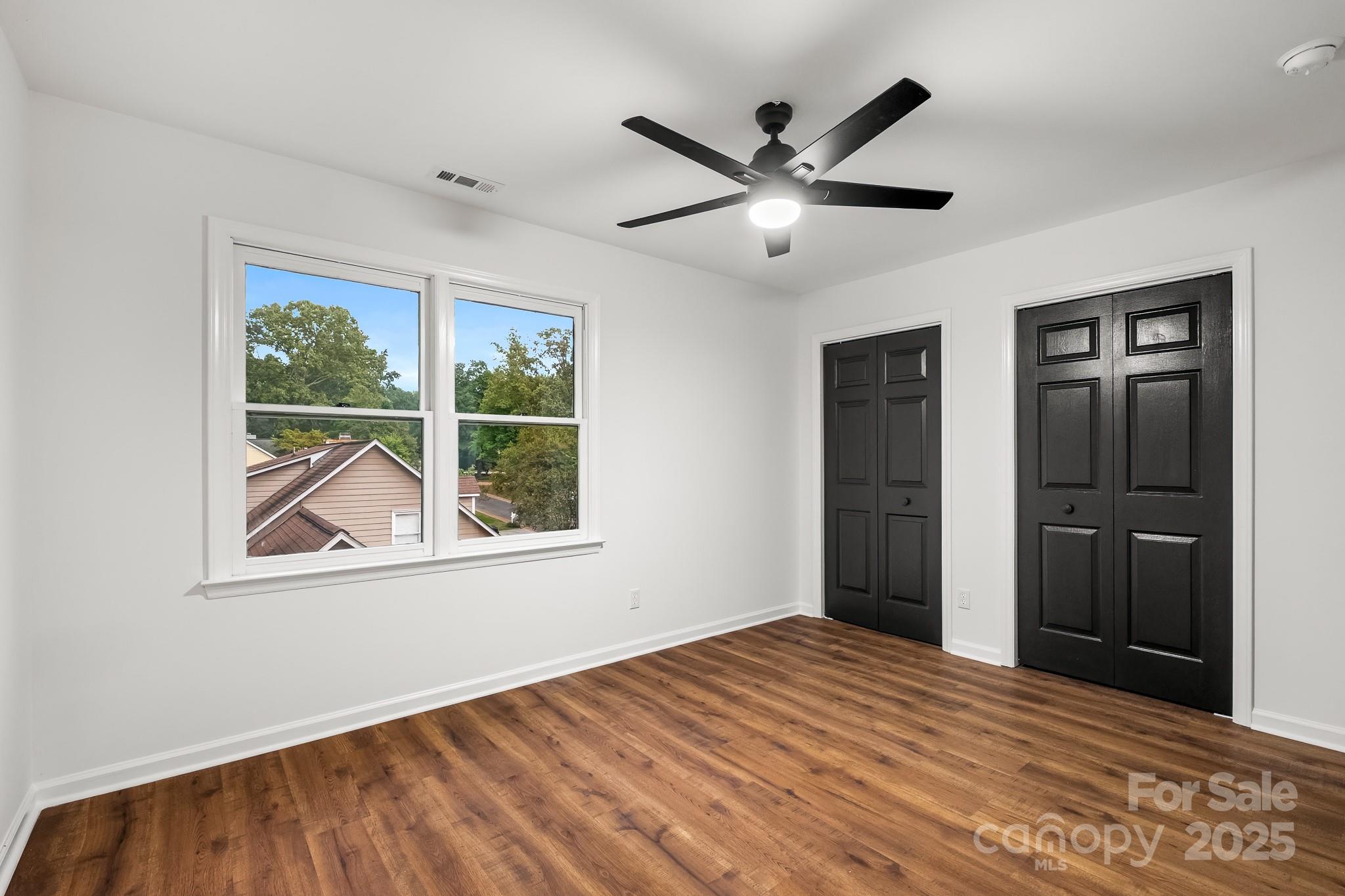 101 Banks Ridge Road Fort Mill, SC 29715 - Photo 13 of 34 a view of empty room with wooden floor and fan