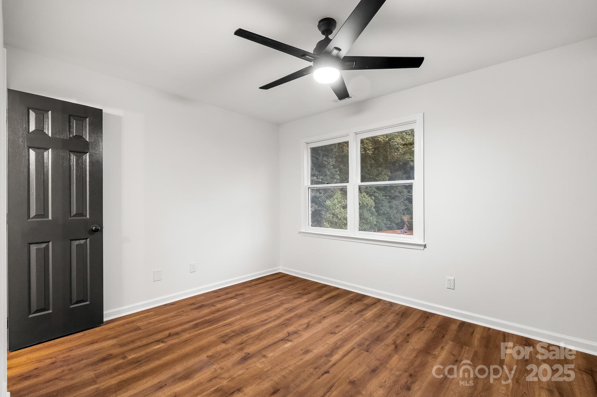 101 Banks Ridge Road Fort Mill, SC 29715 - Photo 14 of 34 an empty room with wooden floor and windows