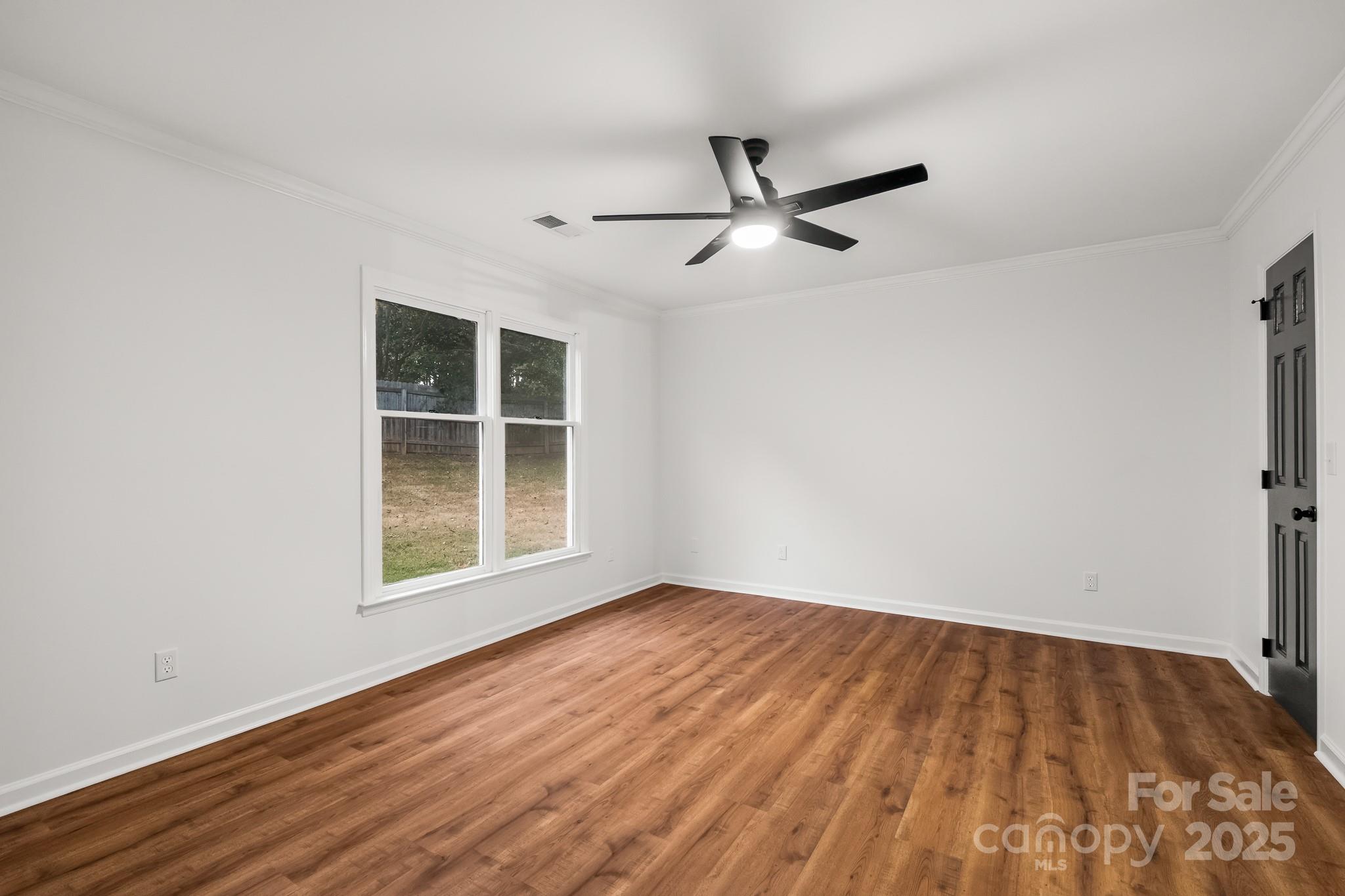 101 Banks Ridge Road Fort Mill, SC 29715 - Photo 22 of 34 an empty room with wooden floor fan and windows
