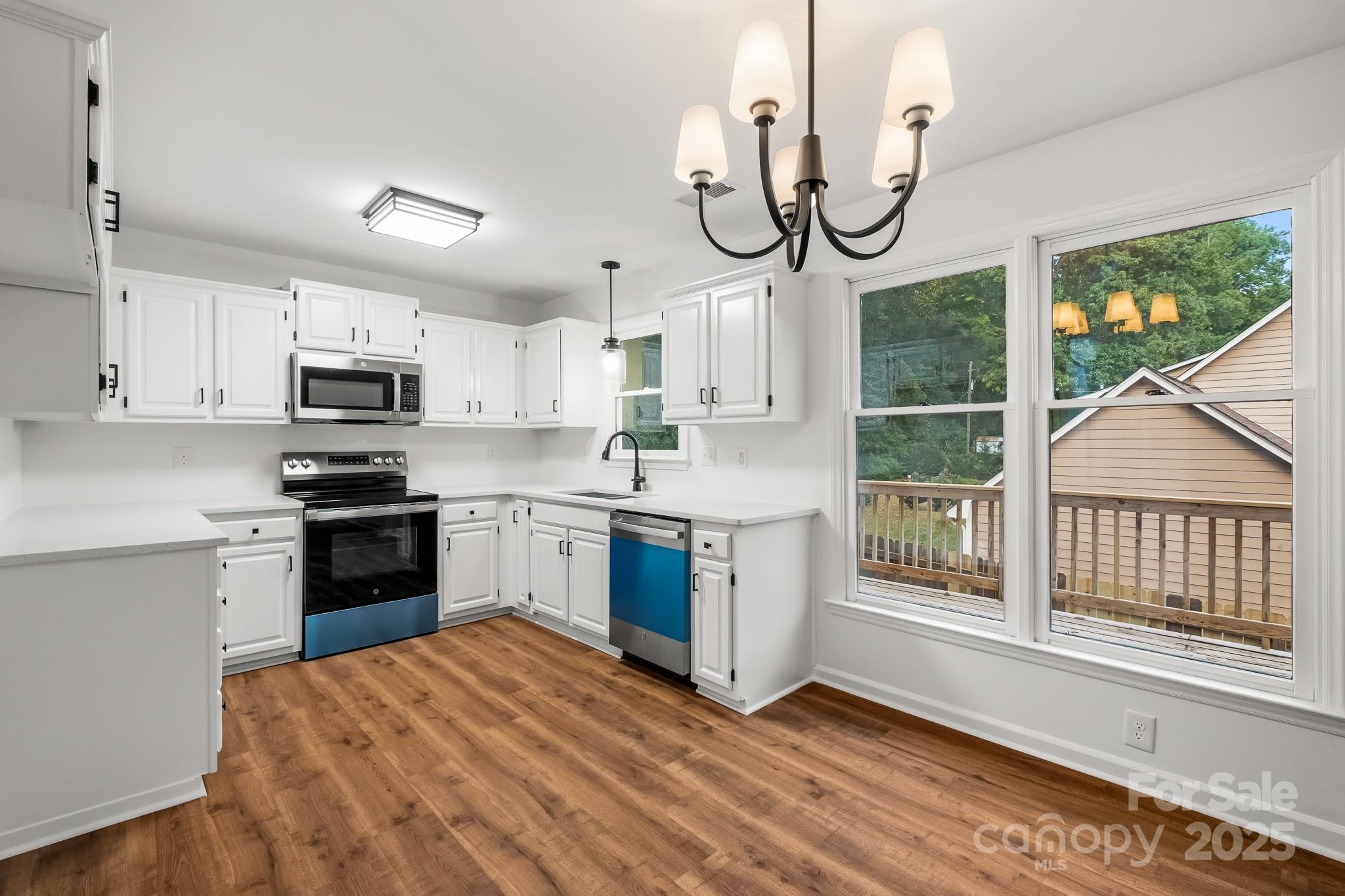 101 Banks Ridge Road Fort Mill, SC 29715 - Photo 4 of 34 a kitchen with stainless steel appliances granite countertop a stove a sink and a microwave