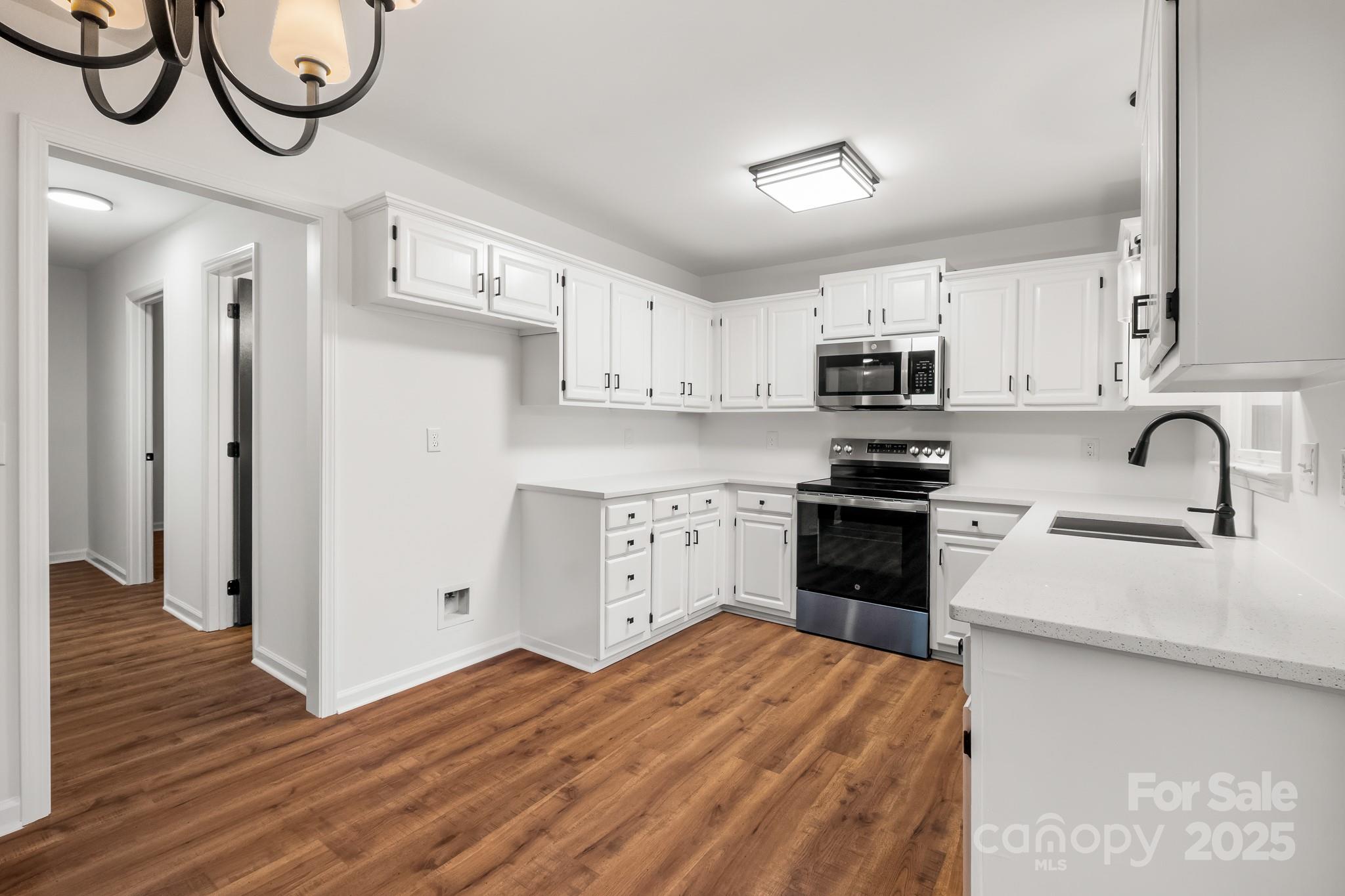 101 Banks Ridge Road Fort Mill, SC 29715 - Photo 5 of 34 a kitchen with stainless steel appliances a stove a sink and a refrigerator