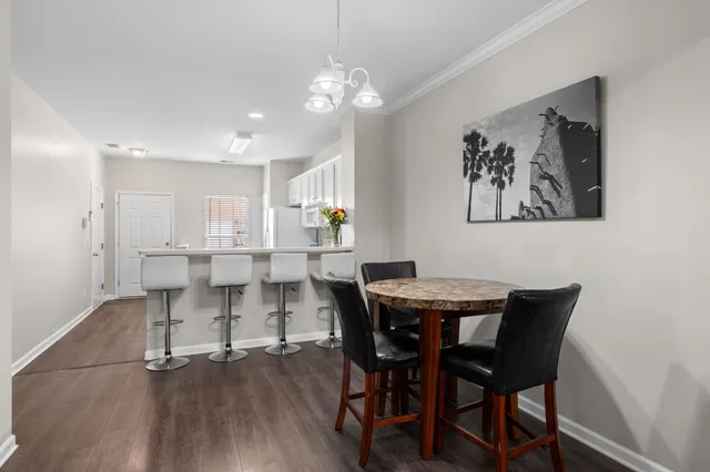 a dining room with furniture and wooden floor