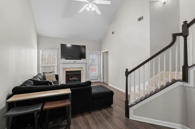 a living room with furniture a flat screen tv and a fireplace