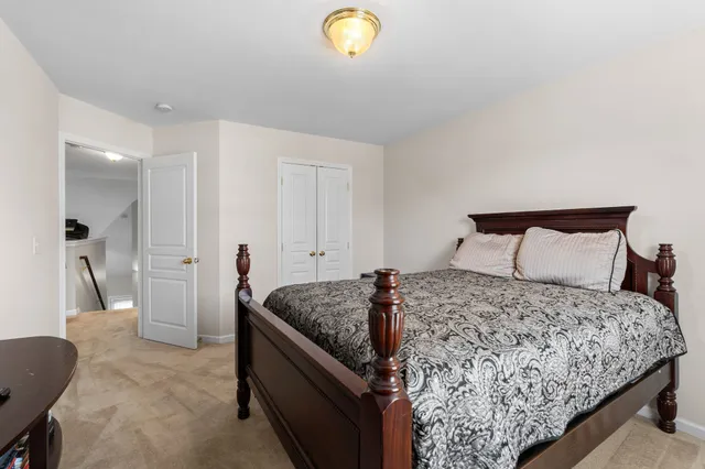 a bedroom with a bed and a lamp