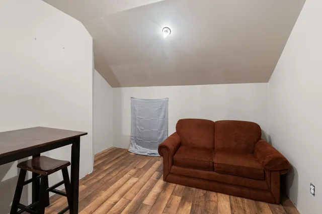 a blue couch sitting in a living room with a chair
