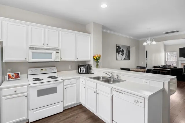 a kitchen with white cabinets sink and white appliances