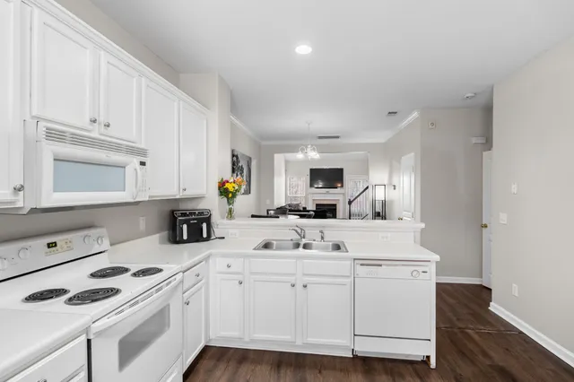 a kitchen with white cabinets sink and white appliances